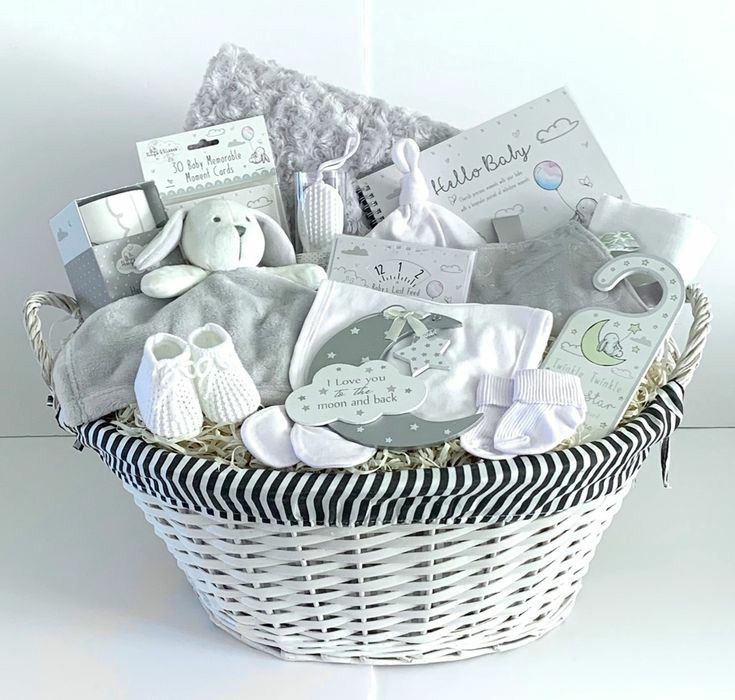 a white basket filled with baby items on top of a table