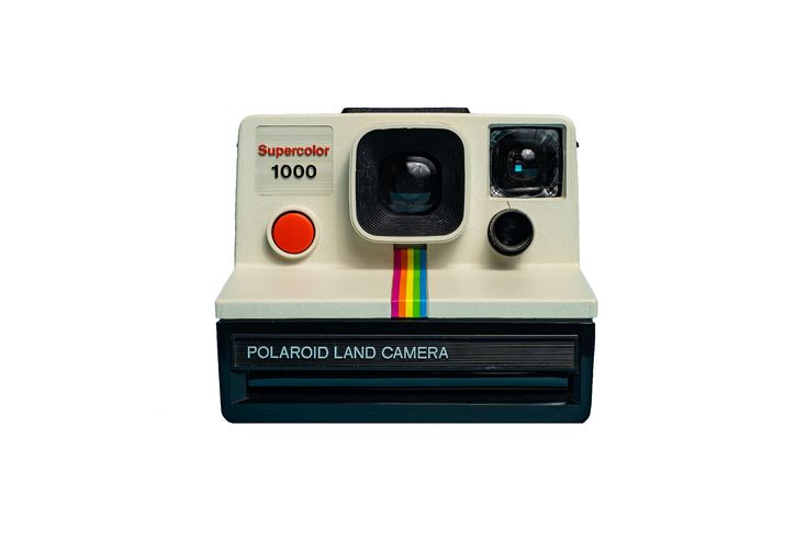 the polaroid land camera is on display in front of a white background with rainbows