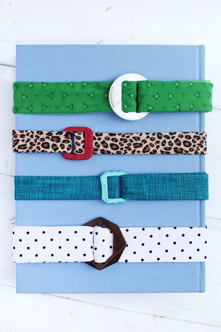 several different types of belts are arranged on a blue and white book with polka dots