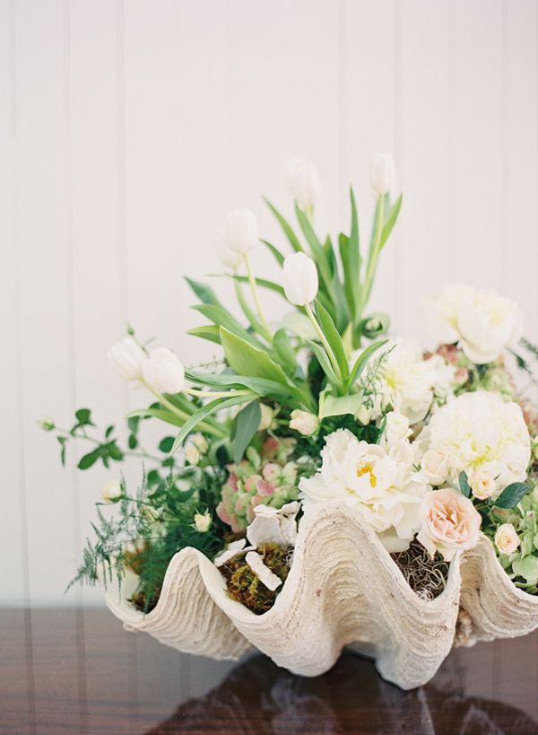 a bouquet of flowers sitting on top of a wooden table