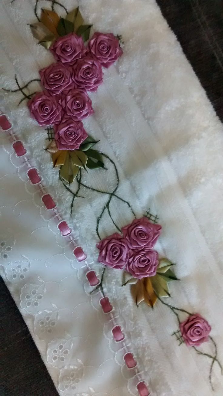 some pink roses are on the white fabric