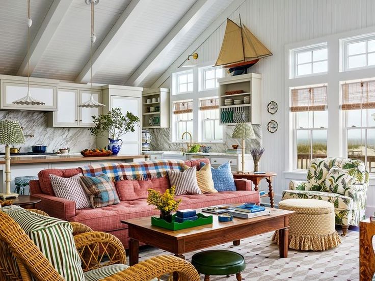 a living room filled with furniture and lots of windows