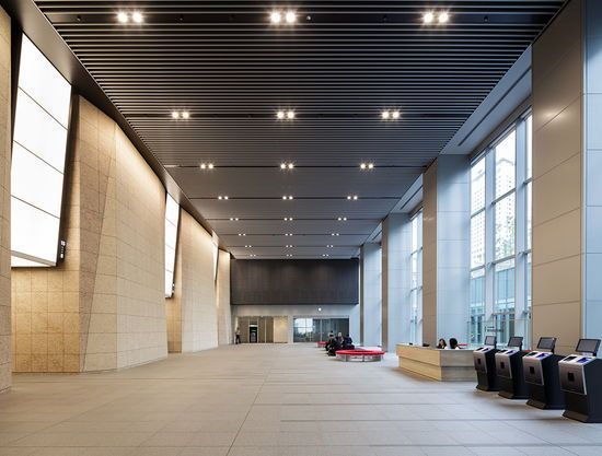 an empty lobby with lots of windows and lights