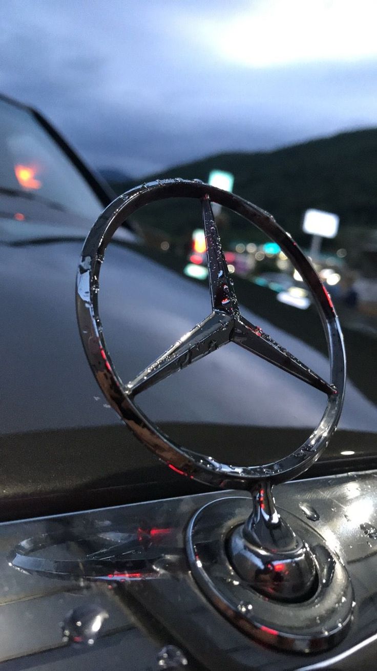 the mercedes emblem is shown on the hood of a car