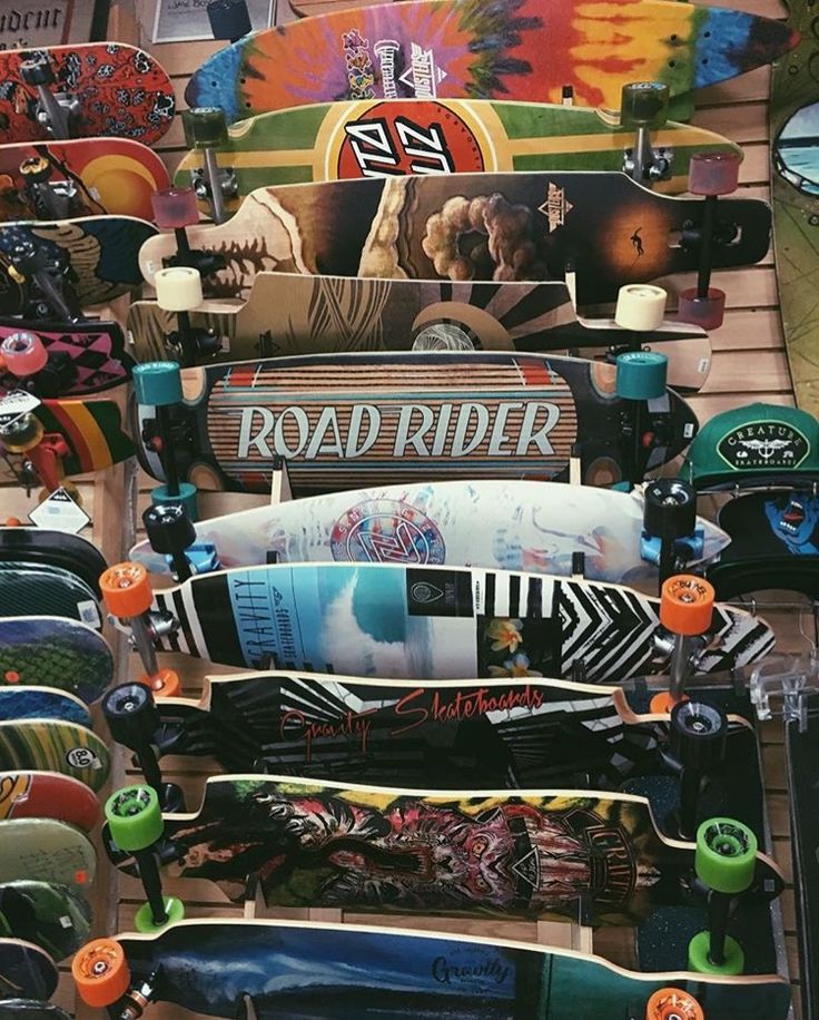 many skateboards are stacked on top of each other