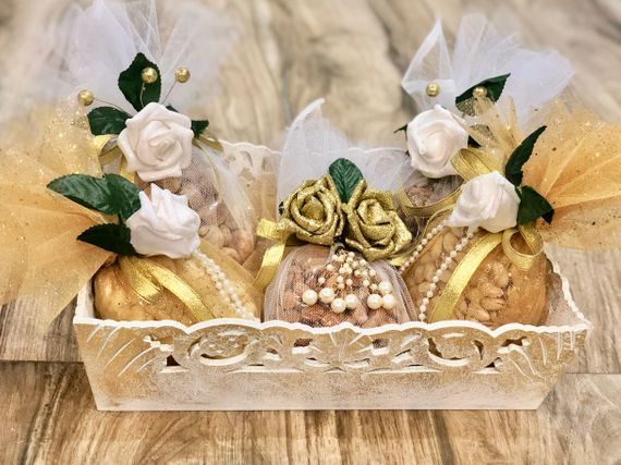 two baskets filled with cookies and flowers on top of a wooden table