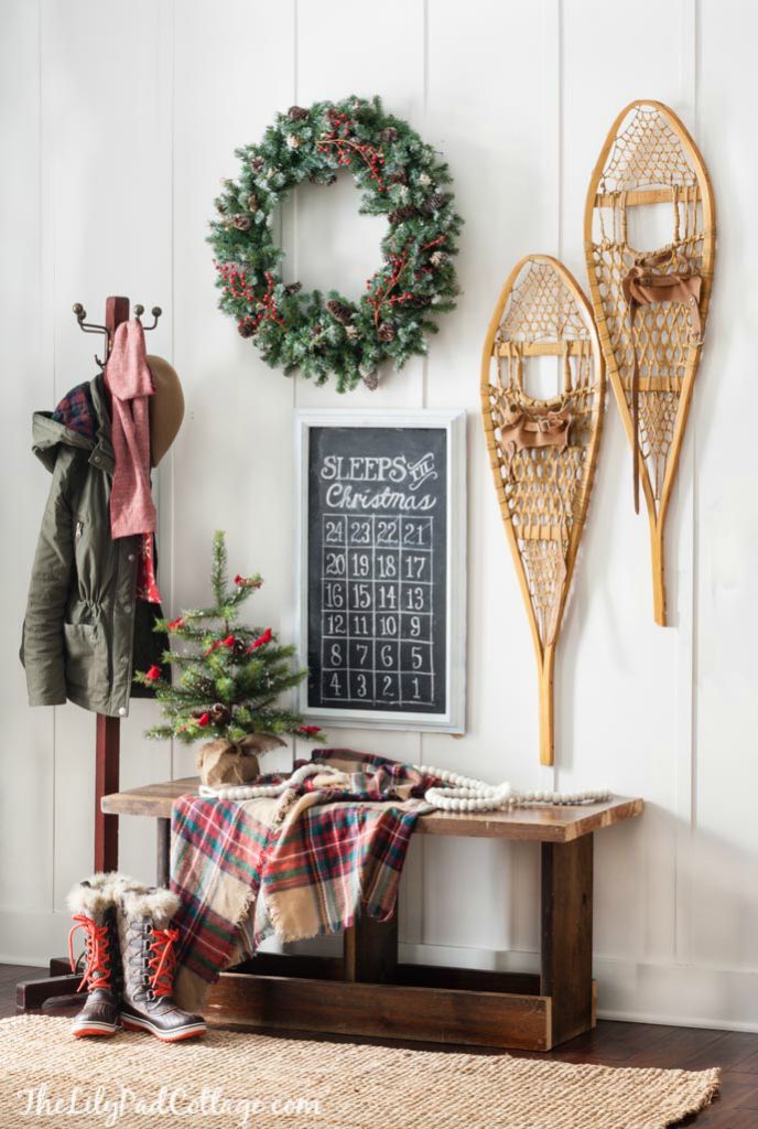 an image of a room decorated for christmas with snowshoes and wreaths on the wall