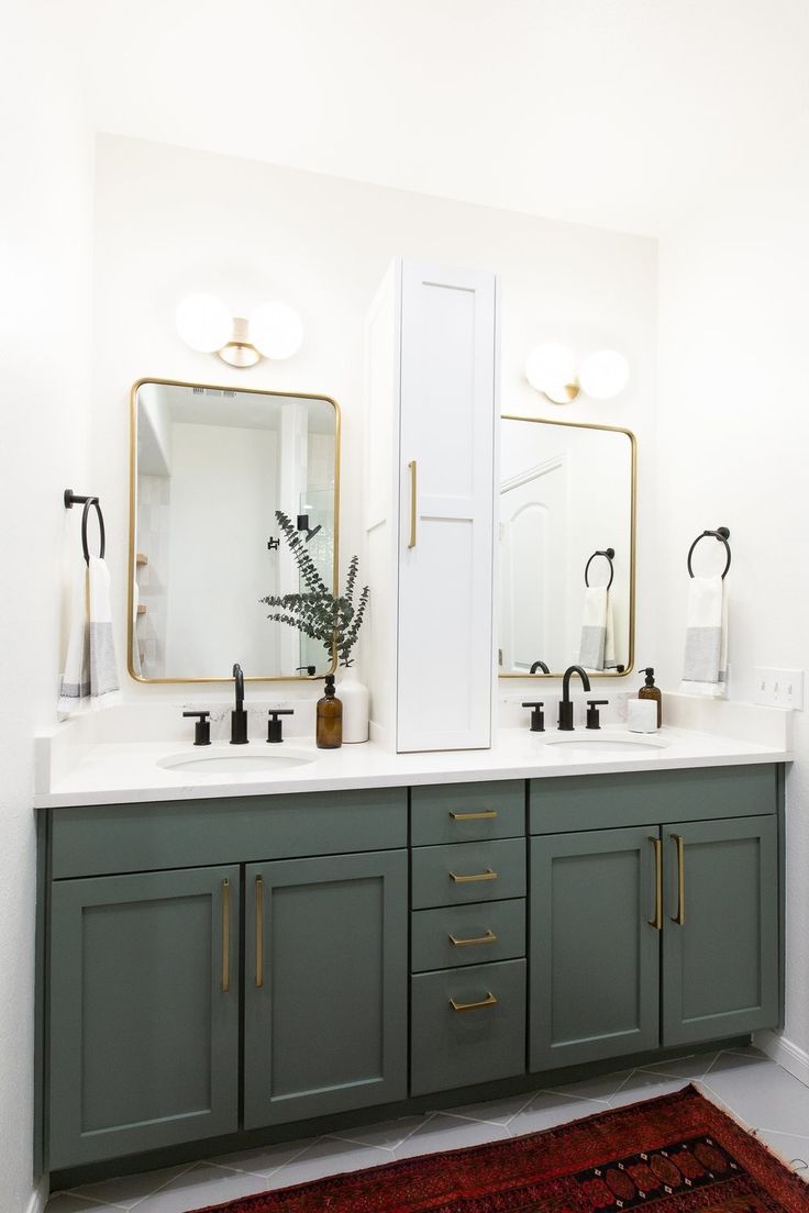 a bathroom with two sinks, mirrors and a rug on the floor in front of it