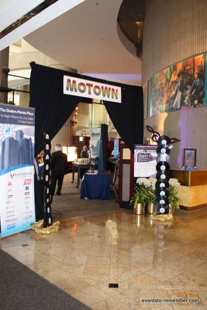 an entrance to a convention hall decorated with black drapes and white polka dot decorations