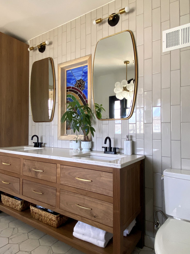 a bathroom with two sinks and mirrors above them