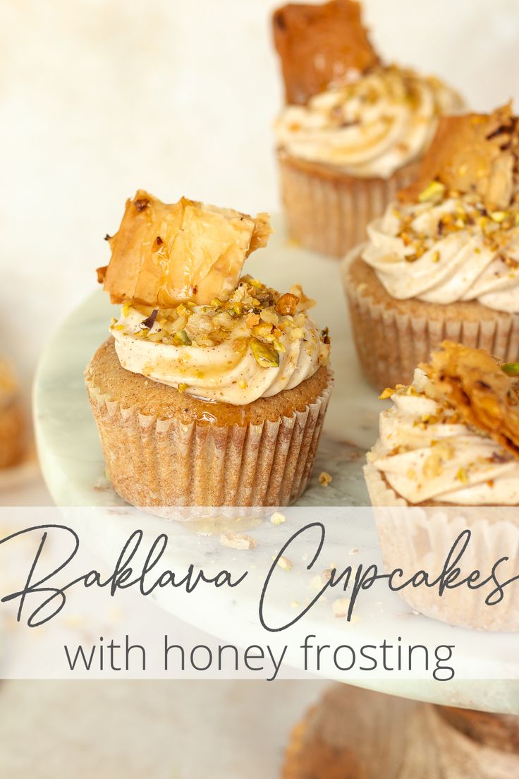 some cupcakes with honey frosting on a white plate and the words bakflano cupcakes with honey frosting