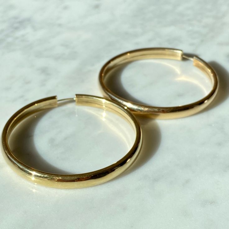 "Solid 14K Italian made Gold Hoops - Looking for an amazing classic gold hoop that will last you a lifetime? This is the hoop! - A classic solid gold look with a flat inner circle creating an edge. - An endless closer meaning you open differently than a lever back. The endless closure creates a look that the hoops goes all around. - 100% 14K gold, meaning they do not change the color of your ear or ever rust. If taken care of, they will easily last a lifetime. Can be taken on vacation and for a Classic 14k Stamped Hoop Earrings, Classic Small Hoop Gold Jewelry, Gold Hoop Earrings Stamped 14k For Wedding, Classic Gold Plated Tarnish Resistant Hoop Earrings, Classic Gold Tarnish Resistant Hoop Earrings, Classic 14k Gold Hoop Earrings With Shiny Finish, Classic Gold Tarnish-resistant Hoop Earrings, Classic Gold Hoop Huggie Earrings, Timeless Gold Plated Hoop Earrings For Anniversary