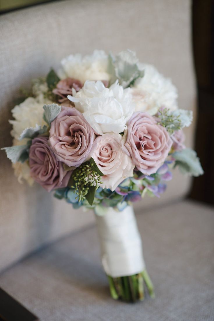 a bridal bouquet with pink and white flowers on the back of a chair for sale