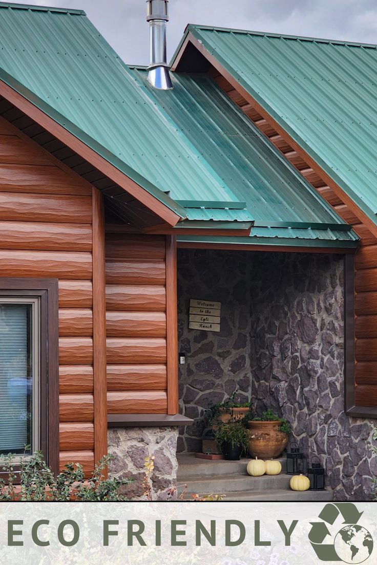 a log cabin with green roof and windows