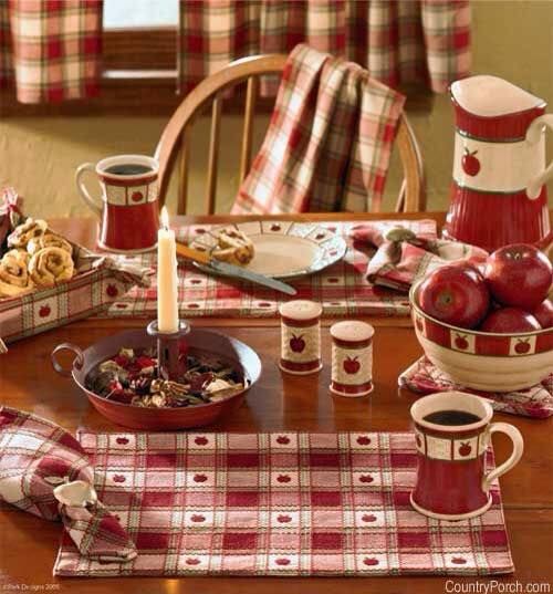 a wooden table topped with dishes and cups filled with food next to a candle on top of a table