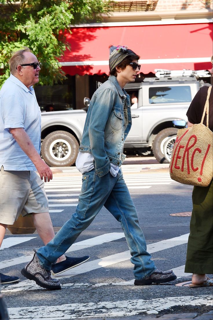 two men walking down the street with bags on their backs and one man carrying a sign that says erc