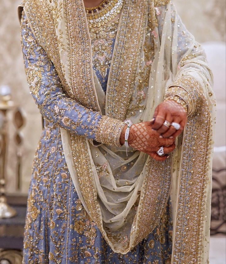 a woman in a blue and gold wedding outfit