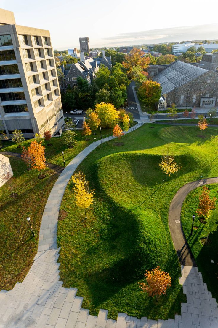 an aerial view of a grassy area in the city