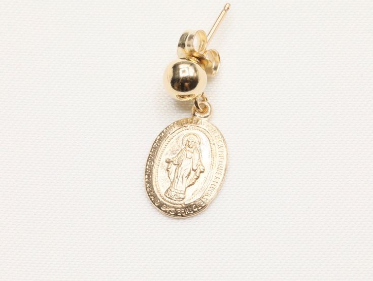 14k Gold Filled Virgin Mary Earrings / Miraculous Earrings / Catholic Jewelry / Gold Coin Jewelry / Catholic Gifts - 9 x 13mm Gold Filled Virgin Mary Pendant - Front design: Mama Mary - Back design: letter M with a cross on top and scattered stars - 14k Gold Filled 5mm stud - Sold as a pair - Tarnish free, hypoallergenic, nickel free and safe for sensitive skin 💰 We guaranteed fair pricing on all our jewelry. 🍃 All our jewelry comes with a modern style packaging, which includes a classy suede Gold Earrings With Charms As A Gift, Gold Earrings With Charms For Gift, Gold Charm Earrings For Gift, 14k Gold-filled Oval Earrings, Gold Drop Earrings With Charms, Yellow Gold Charm Earrings For Gift, 14k Gold Filled Charms Drop Earrings, 14k Gold Filled Drop Earrings With Charms, Yellow Gold 14k Charm Earrings