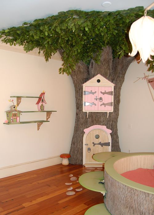 a room with a tree in the corner and shelves on the wall, along with toys