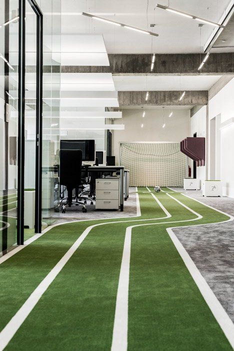 an office with green carpet and white walls