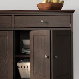 a bowl of fruit on top of a wooden cabinet