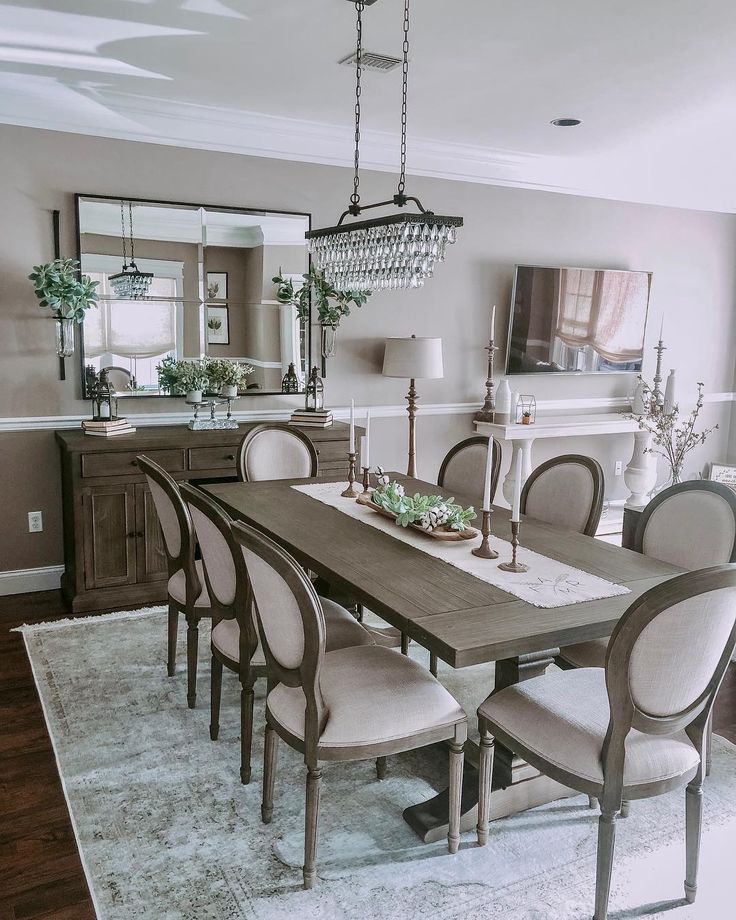 a dining room table with chairs and a chandelier