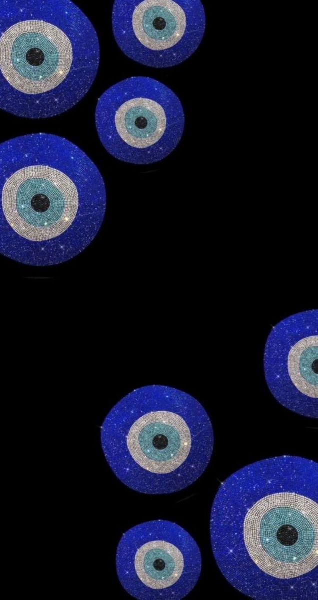 several blue and white eyeballs on a black background