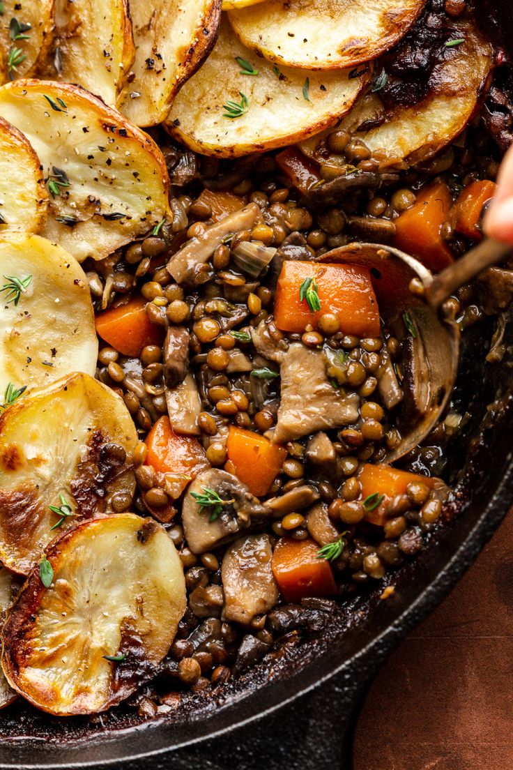 a skillet filled with potatoes and lentils