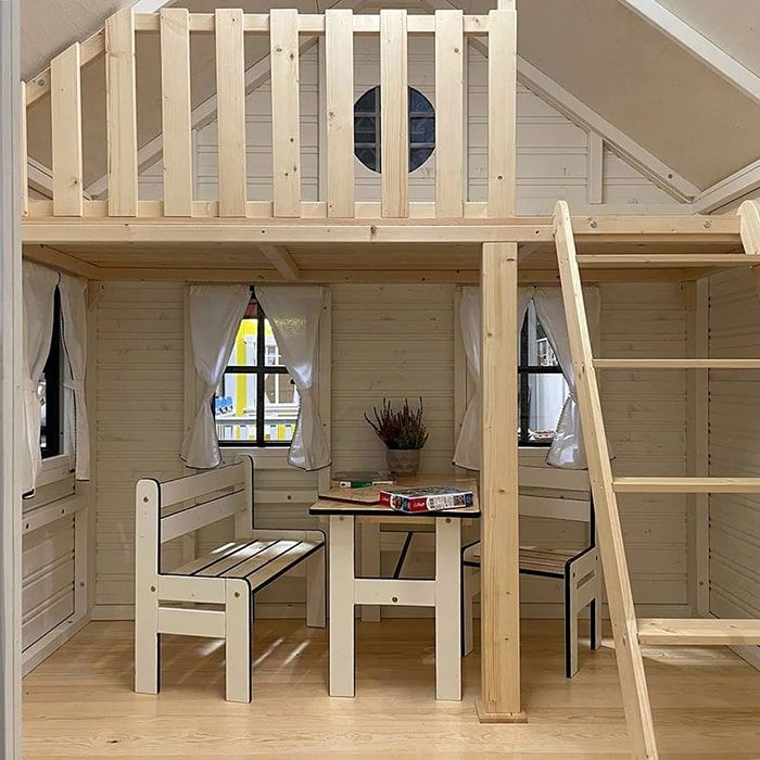 there is a loft bed with stairs to the second floor and table underneath it,