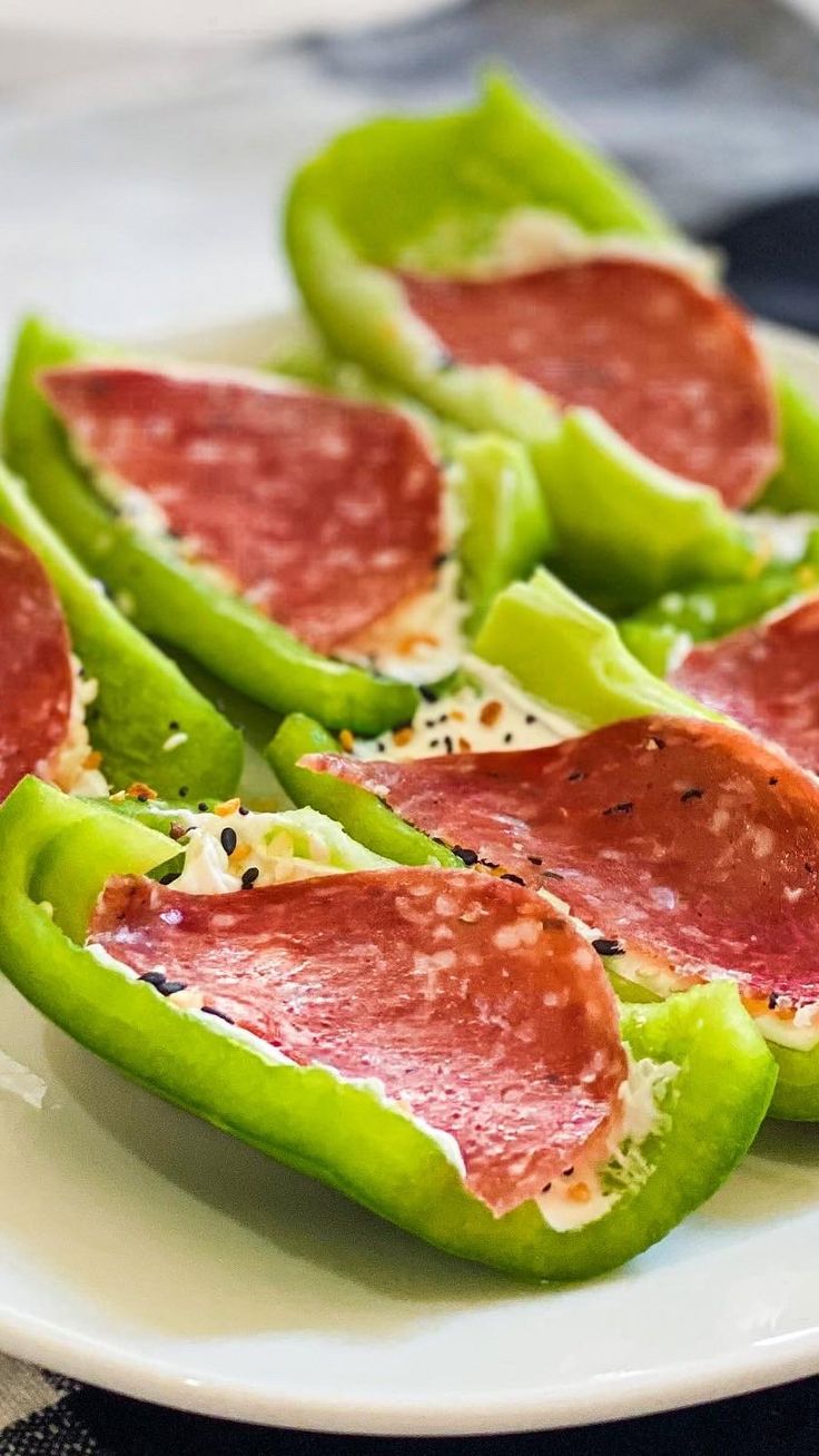 pepperoni and cheese stuffed peppers on a white plate