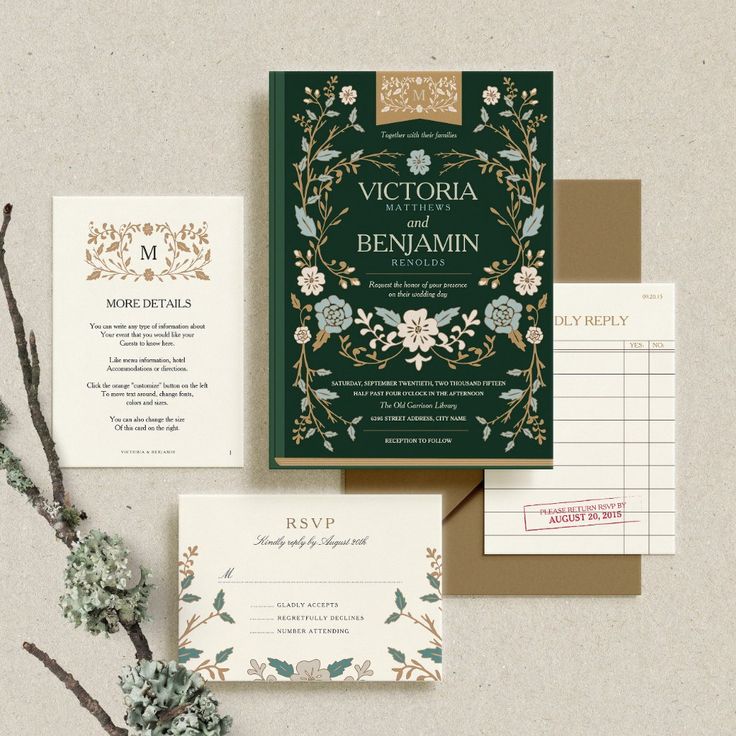 the wedding stationery is laid out on top of each other, with flowers and foliage