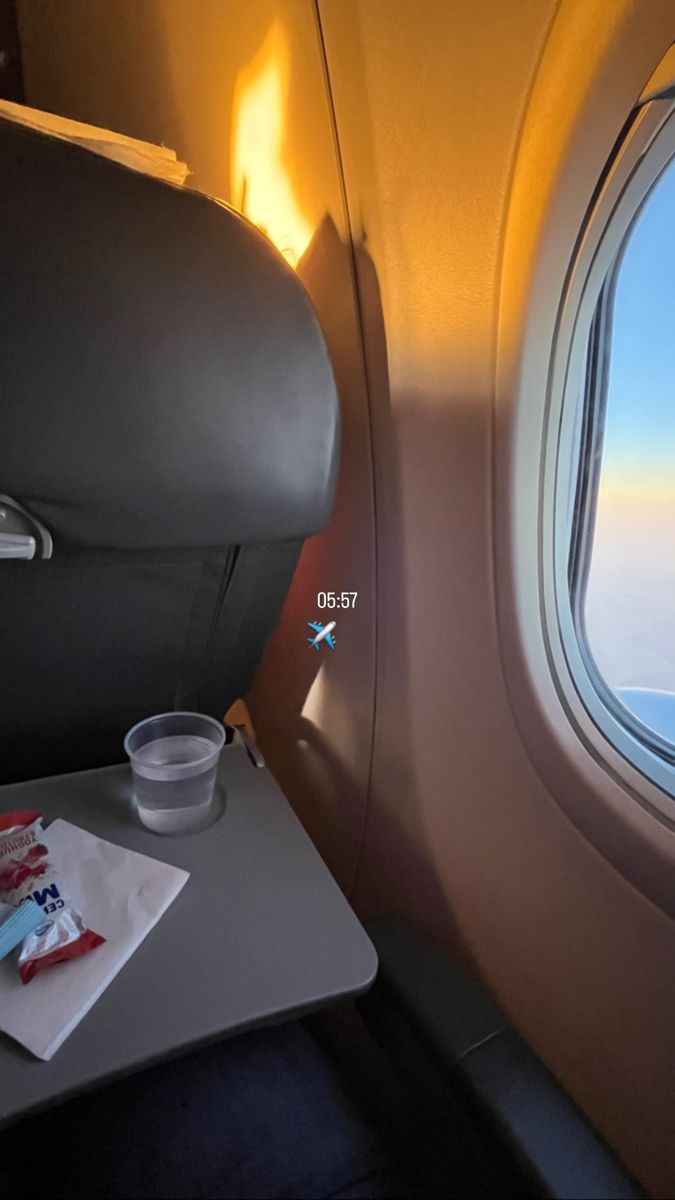 the view from inside an airplane looking out at the wing and water on the table