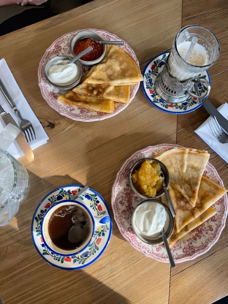 two plates with quesadillas on them and some dipping sauces next to each other