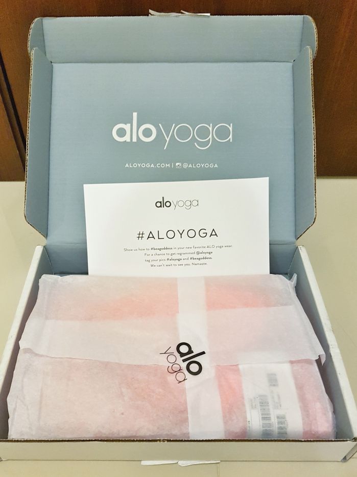 the box is open and has pink towels in it, along with an ad for aloyoga