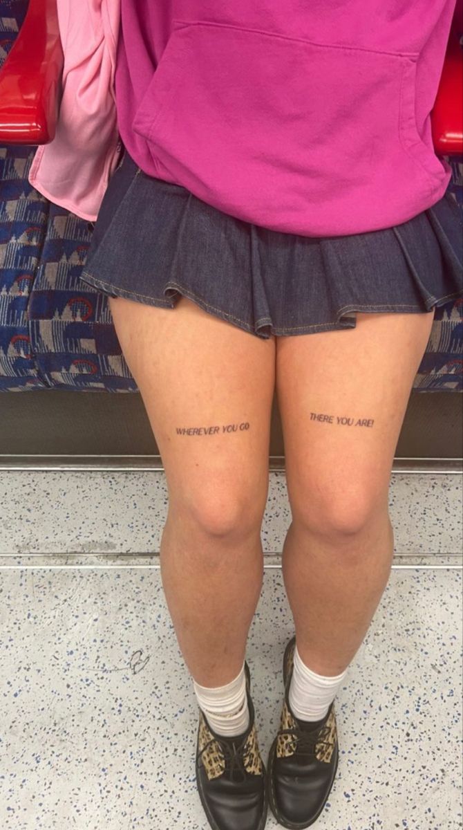 the legs and thighs of a person wearing short shorts with words written on their ankles