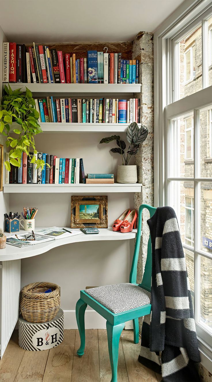 a room that has some books on the shelves and a chair in front of it