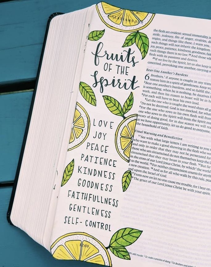 an open book with fruit of the spirit written on it