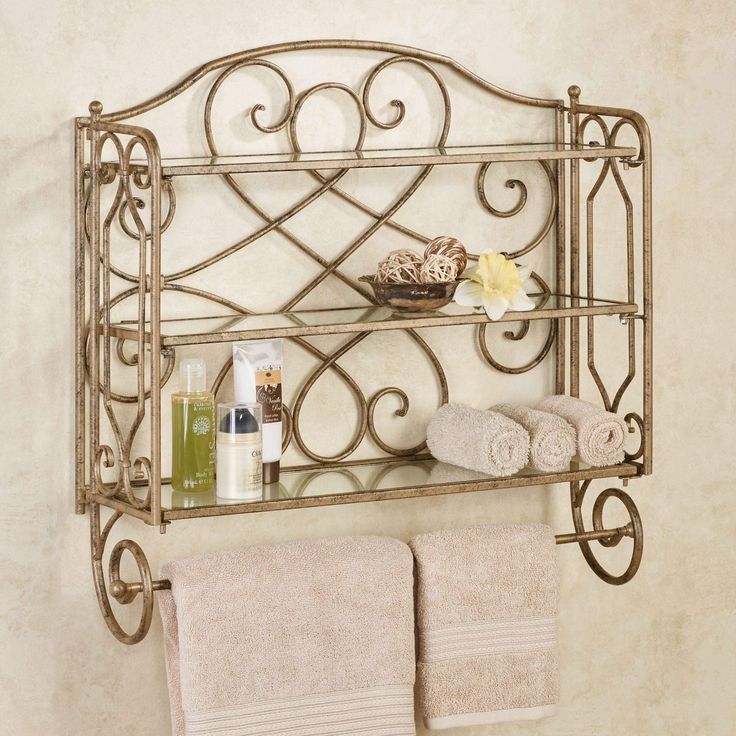 a bathroom shelf with towels and soaps on it