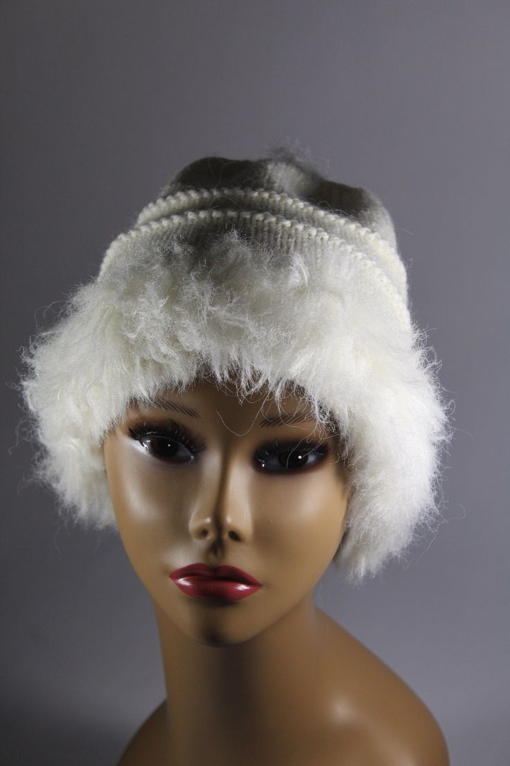 "This hand knit hat is knit with two yarns. A faux fur in white and a blended yarn of 65% wool and 35% alpaca in white. It is of medium weight, approximately 8 1/2\" in length. This fun looking knit hat with white faux fur trim is fun and sassy! Wear it with style for the winter! CARE INSTRUCTIONS Dry Clean Only" White Winter Hat, One Size Fits All, White Winter Hat One Size Fits All, White Winter Hat One Size, White One-size Hat For Winter, White One-size Bonnet For Cold Weather, White One Size Bonnet For Cold Weather, One Size White Bonnet For Cold Weather, White Warm Bonnet One Size, White Soft Knit Winter Hat