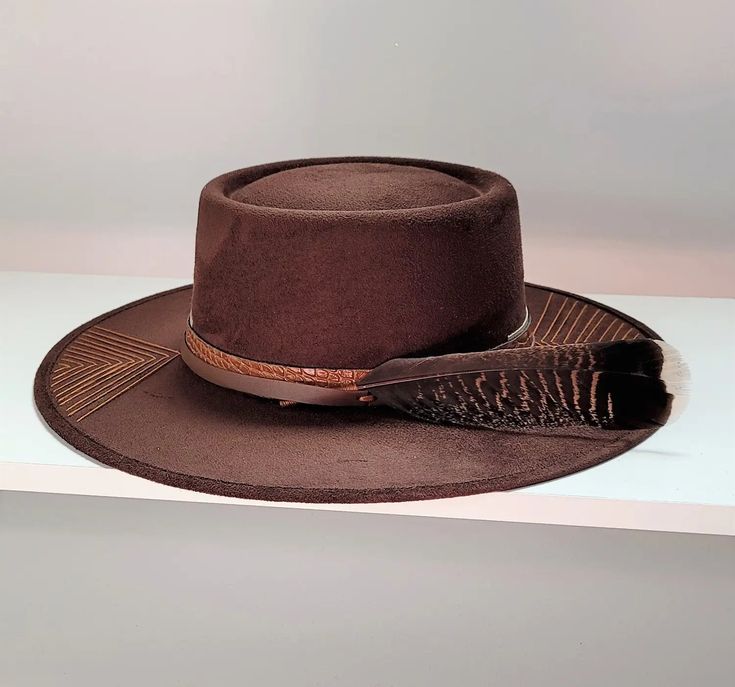 A Delicate embroidery around the brim, leather cord and feather contemporary suede hat styled with a classic molded bolero crown. Hat Embellishments, Leather Bolero, Bolero Hat, Erimish Bracelets, Suede Hat, Delicate Embroidery, Heel Slippers, Western Hats, Capri Blue