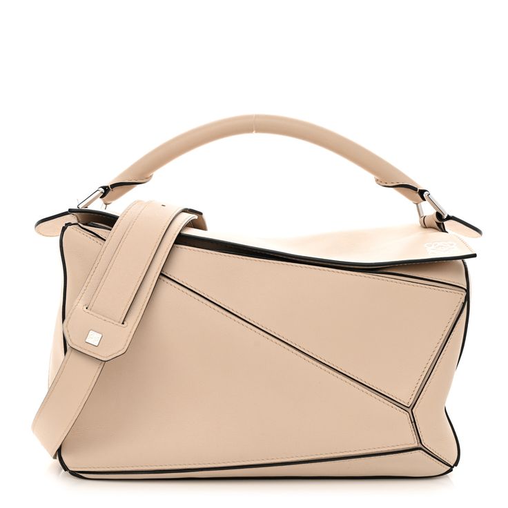 This is an authentic LOEWE Calfskin Medium Puzzle Bag in Ash. This stunning bag is crafted of calfskin leather in light beige. The bag features a rolled leather handle, a rear zipper pocket, and an adjustable leather shoulder strap with polished gold hardware. The top zipper opens to a natural fabric interior with patch pockets. Puzzle Bag, Natural Fabric, Natural Fabrics, Light Beige, Leather Handle, Gold Hardware, Patch Pocket, Zipper Pocket, Calf Skin