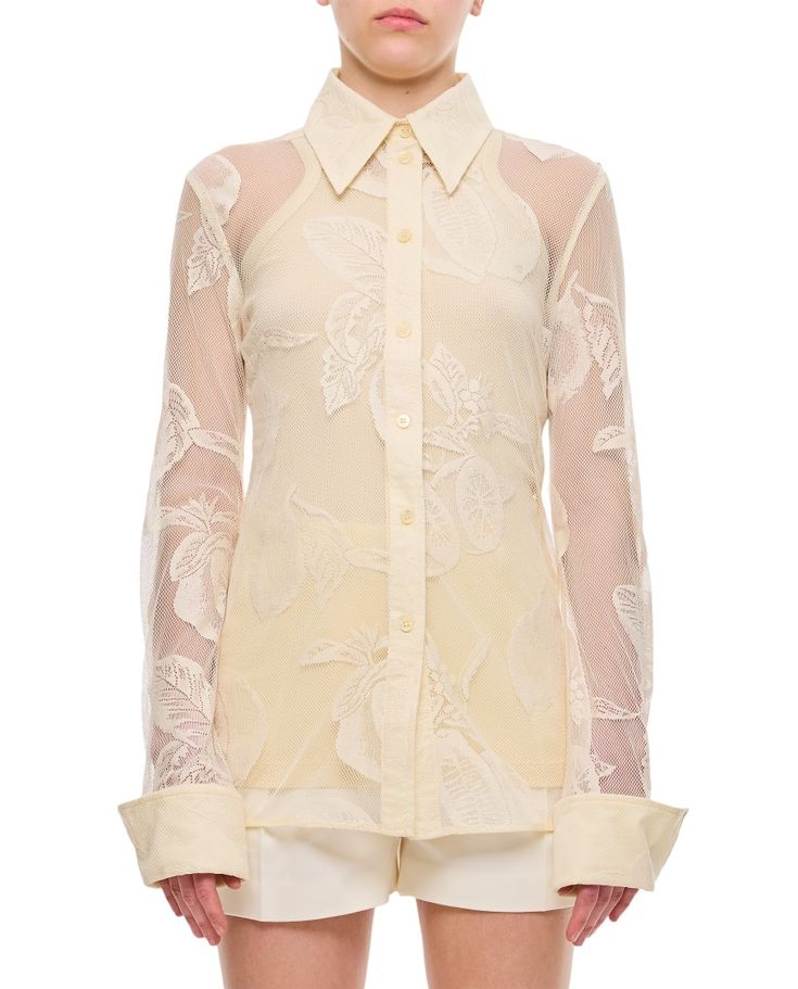 This Sportmax lace shirt features a pointed collar and intricate see-through floral patterns, making it suitable for both elegant and casual occasions. The refined buttoned closure and cuffs add to its feminine charm.

- Pointed collar  
- See-through floral patterns  
- Buttoned closure  
- Cuffs Designer White Shirt With Button Cuffs, Designer Spring Shirt With Button Cuffs, Luxury White Collared Blouse, Elegant Shirt With Covered Buttons For Spring, Designer Lapel Collar Top For Spring, Designer Spring Tops With Button Cuffs, Semi-formal Spread Collar Blouse For Spring, Semi-formal Spring Blouse With Spread Collar, Designer White Tops With Button Cuffs