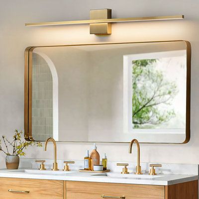 a bathroom vanity with two sinks and a large mirror over the sink that's mounted above it