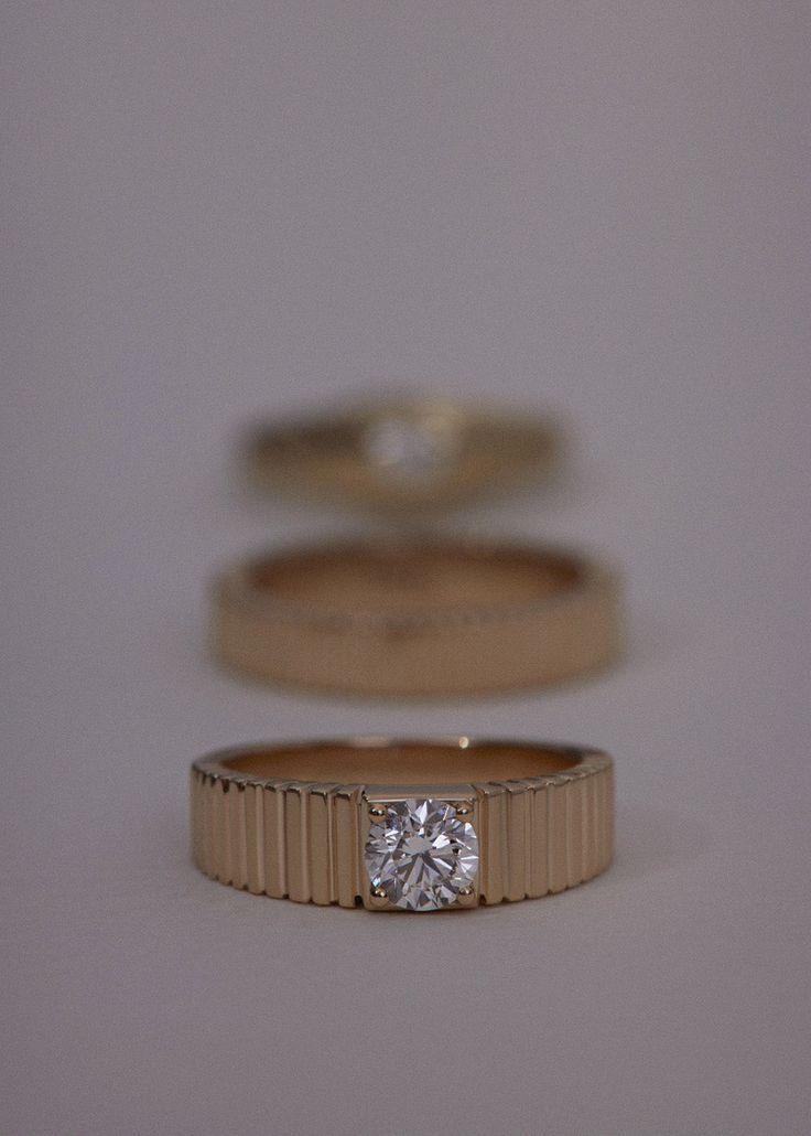 Inspired by Jennie's mother, Sun's vintage pleated ring, the Solis collection represents energy and strength. Features a round brilliant diamond prong set in a 14k solid gold ribbed band. This piece is not eligible for discounts. We also offer a variety of gemstones. Please email hey@kinnstudio.com to find out if we can source and set your desired gemstone. 14k solid gold—always. Non-hollow Weight: 5.37g Band width: 5mm (front), 3.5mm (back) Total carat weight: 0.50ctw Diamond cut: Round Brillia Diamond Rings With Fluted Bezel For Wedding, Timeless Round Ring With Single Diamond, Wedding Diamond Ring With Fluted Bezel, Timeless Round Single Diamond Ring, Timeless Single Diamond Ring, Modern Formal Rings With Fluted Bezel, Classic Rings With Fluted Bezel, Luxury Rings With Single Diamond And Round Band, Luxury Ring With Single Round Diamond