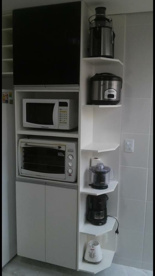 there is a microwave and other appliances in this kitchen