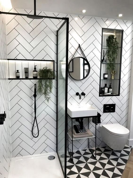 a bathroom with black and white tiles on the walls