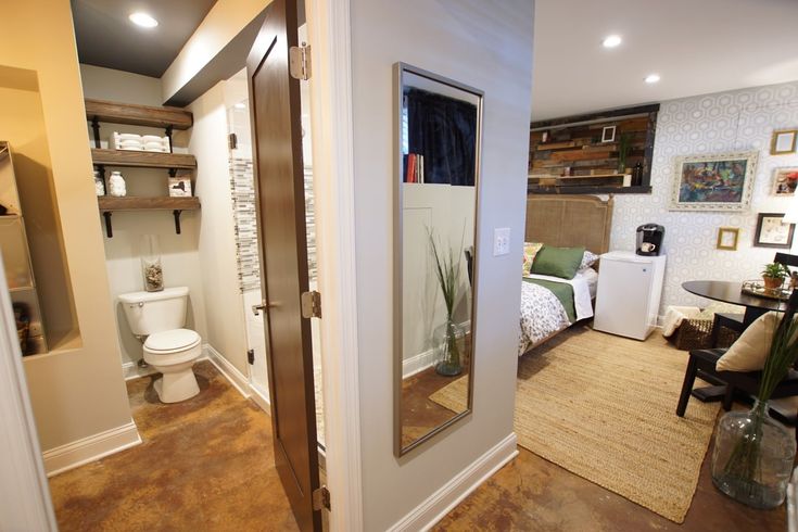 an open door leading to a bathroom and bedroom