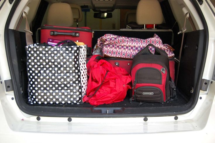 luggage is packed in the back of a car