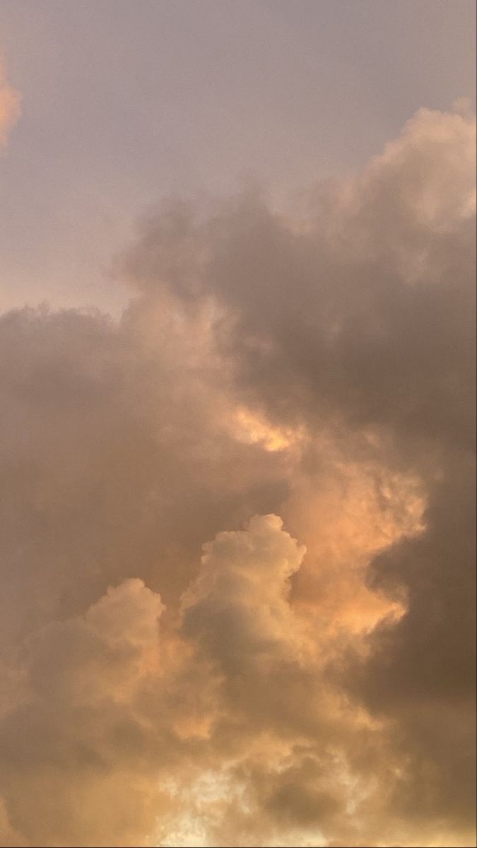 an airplane is flying in the sky with clouds behind it and sun shining through the clouds